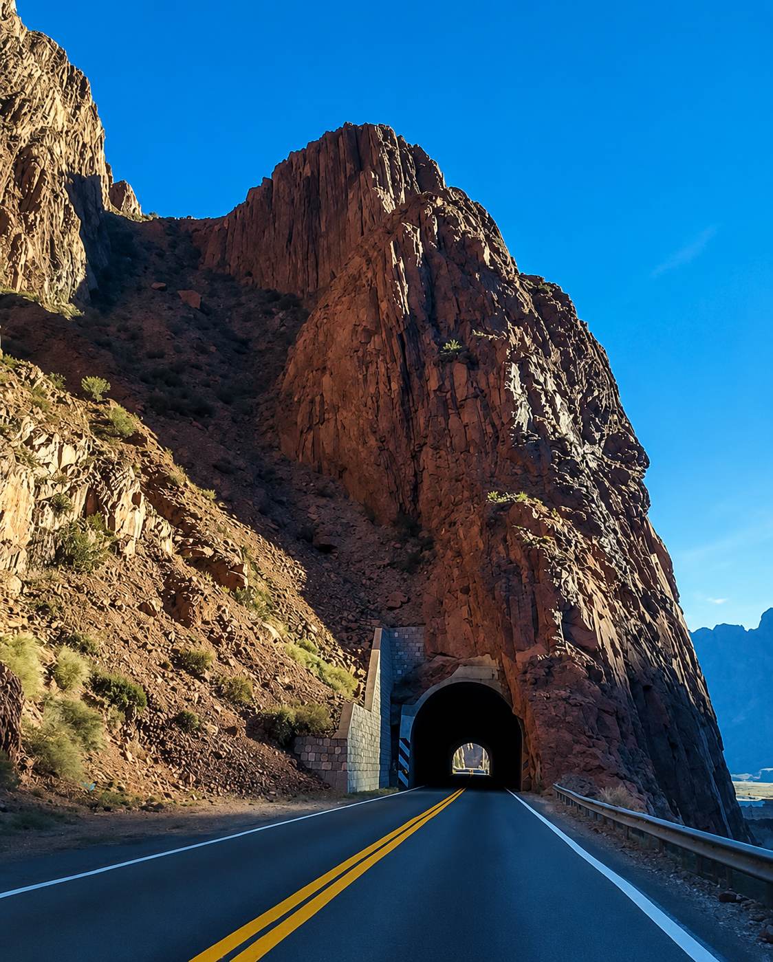 Mountain road cutting through the red rock of the Andes, on the way to Mendoza's high peaks